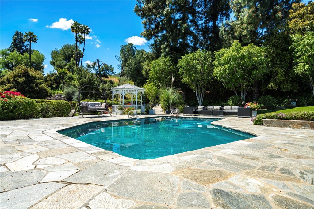 4420 Conchita Way Tarzana, CA 91356 - Photo 42 of 53 a view of a swimming pool with an outdoor space and seating area
