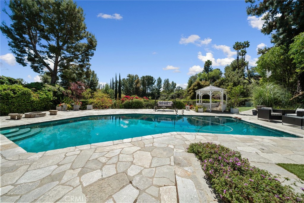 4420 Conchita Way Tarzana, CA 91356 - Photo 43 of 53 a view of a swimming pool with a yard and sitting area