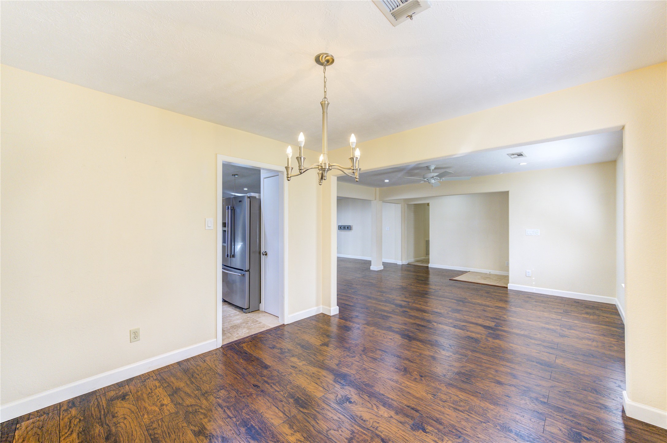 8826 Rowan Lane Houston, TX 77036 - Photo 12 of 26 a view of a livingroom with a chandelier fan and wooden floor