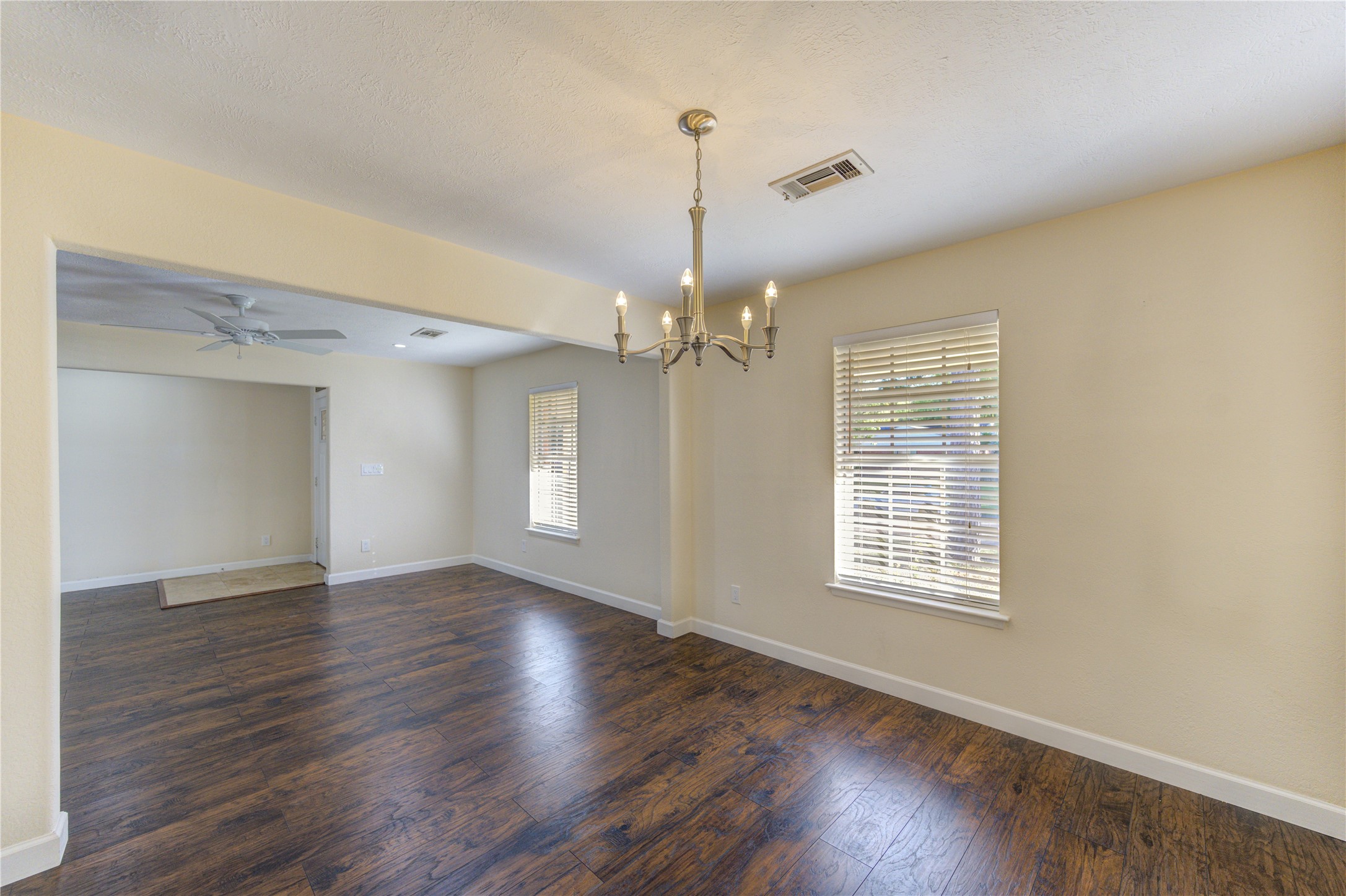 8826 Rowan Lane Houston, TX 77036 - Photo 13 of 26 a view of an empty room with wooden floor and a window