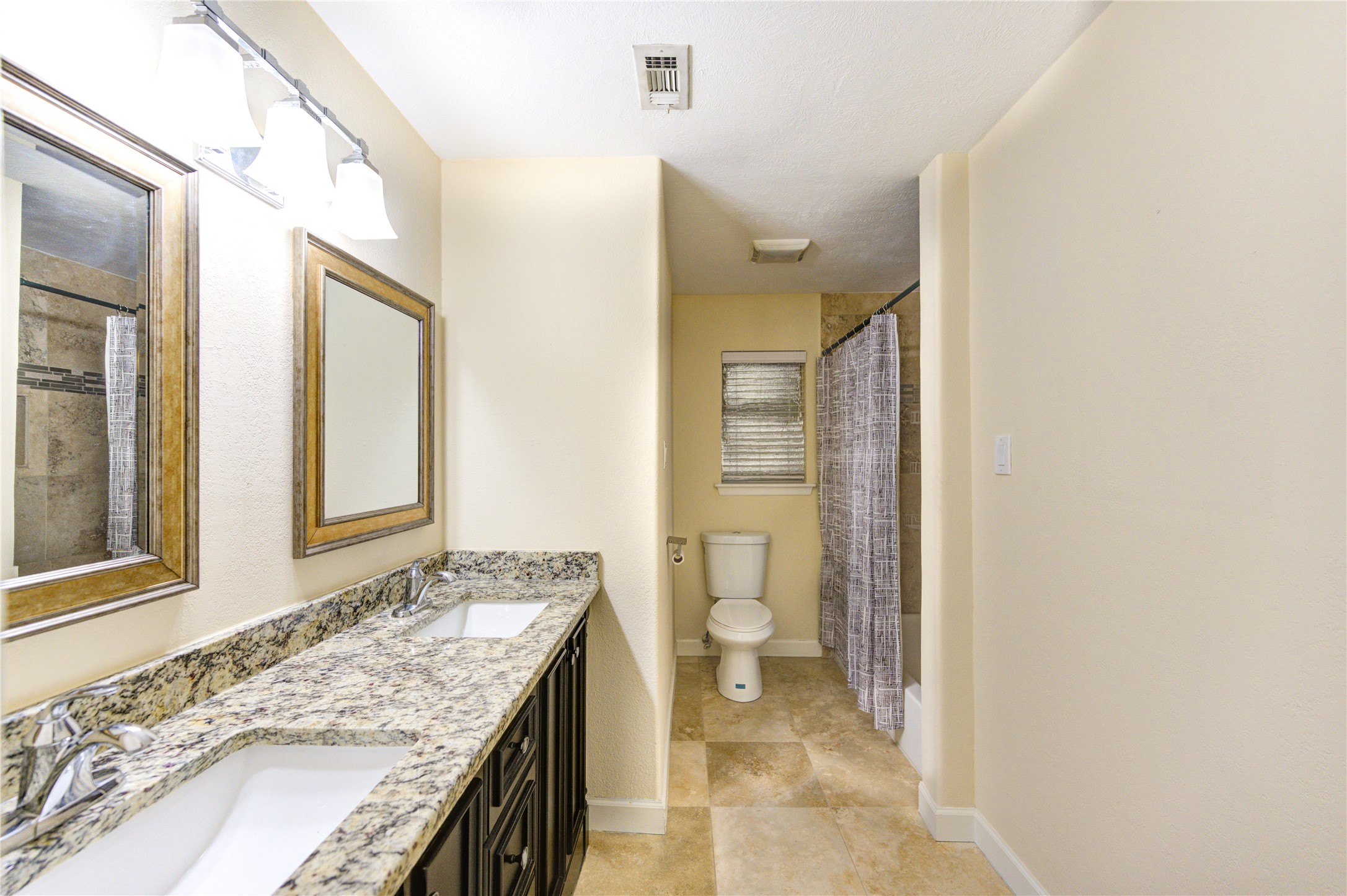 8826 Rowan Lane Houston, TX 77036 - Photo 16 of 26 a bathroom with a granite countertop sink and a mirror