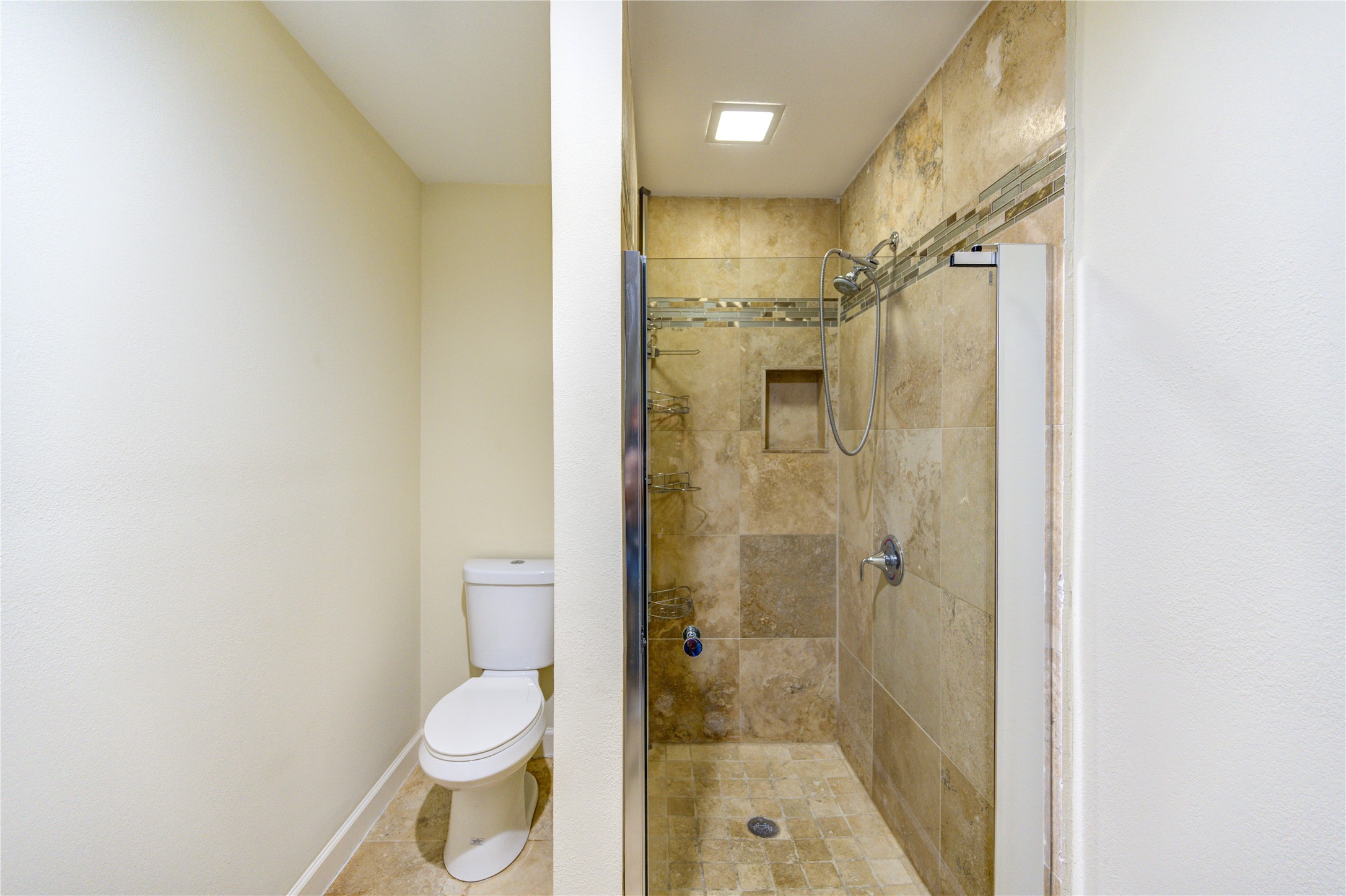 8826 Rowan Lane Houston, TX 77036 - Photo 21 of 26 a bathroom with a shower and a toilet