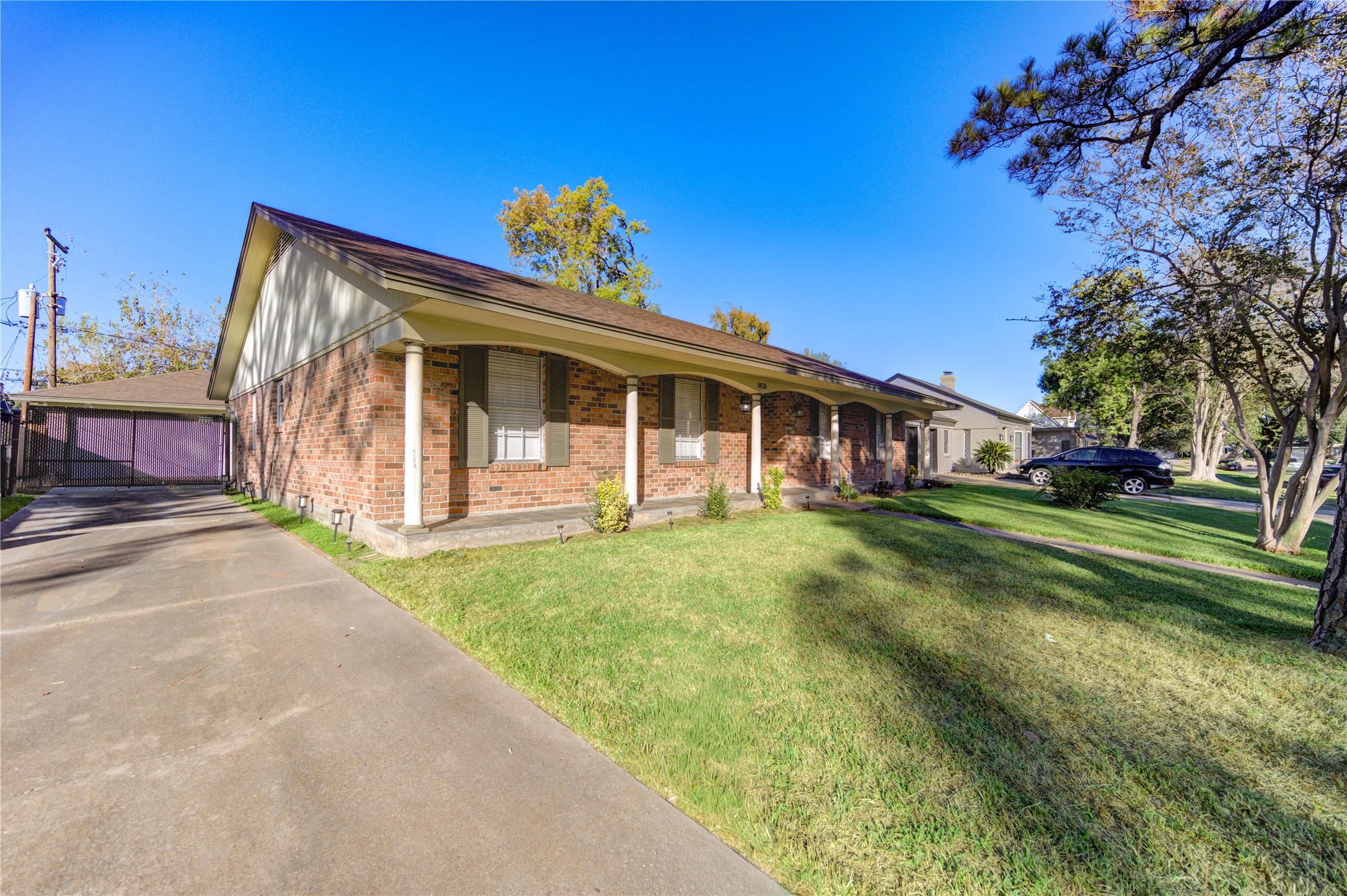 8826 Rowan Lane Houston, TX 77036 - Photo 3 of 26 a view of a house with a yard and a garden