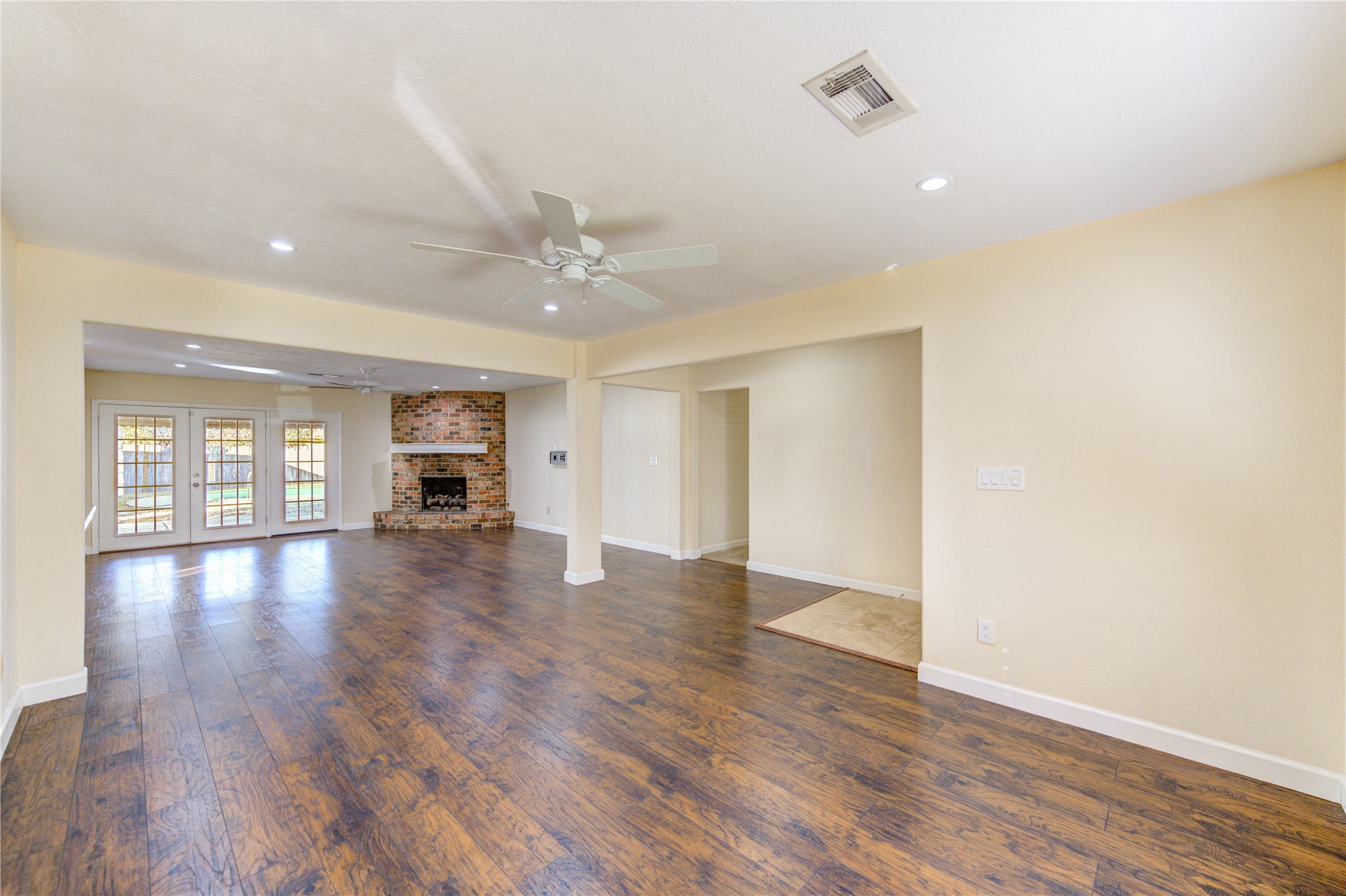 8826 Rowan Lane Houston, TX 77036 - Photo 10 of 26 a view of empty room with wooden floor and fan