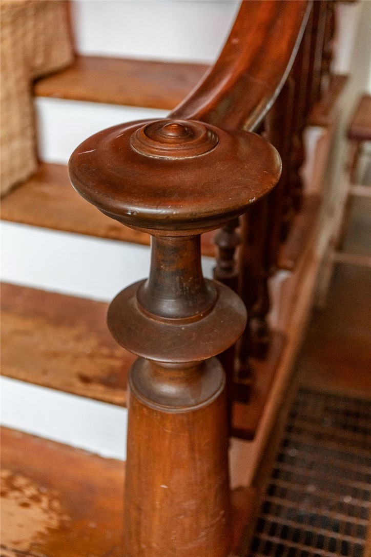67 Fisk Road Bovina, NY 13753 - Photo 28 of 48 An ornate wooden banister post highlights the historic craftsmanship of the interior staircase.