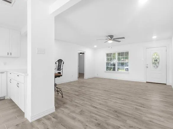 a view of kitchen with granite countertop cabinets and window