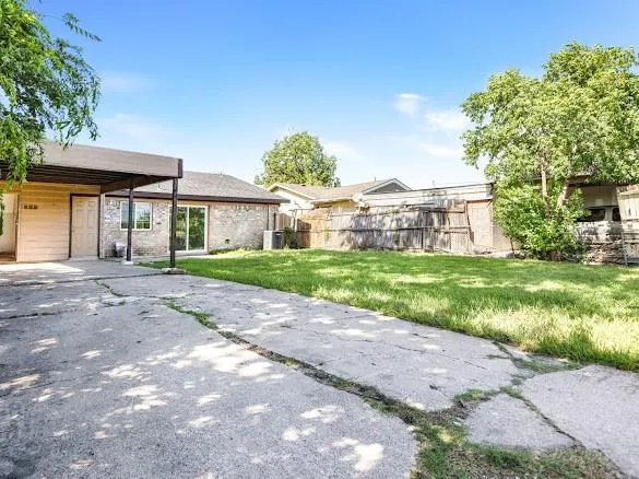 a view of kitchen with stainless steel appliances kitchen island granite countertop a refrigerator a stove a sink and a dining table with wooden floor