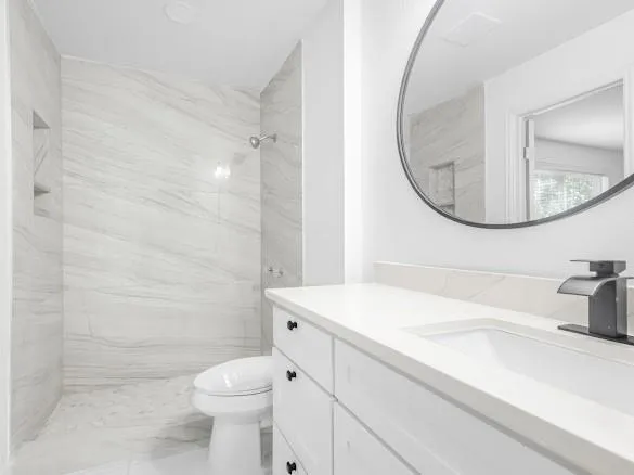 a bathroom with a sink a toilet and a mirror