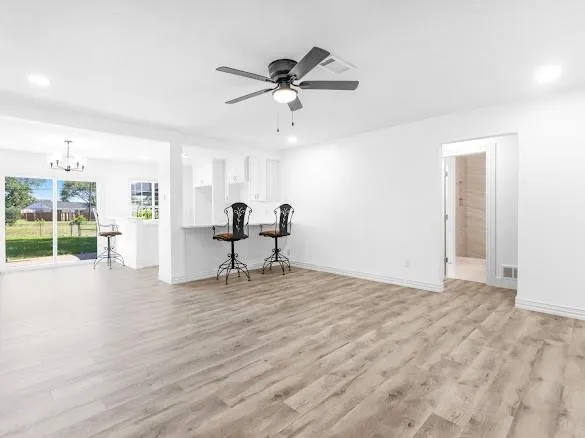 a view of a livingroom with a chair and wooden floor
