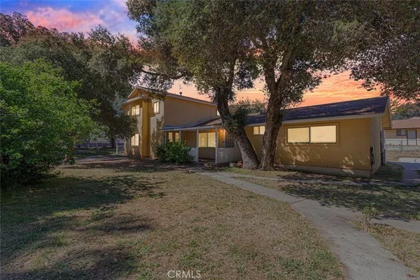 a view of a house with a tree