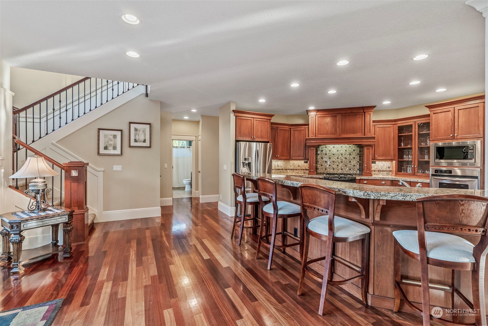 19501 Northwest Krieger Road Ridgefield, WA 98642 - Photo 11 of 38 a living room with stainless steel appliances kitchen island granite countertop furniture and a wooden floor