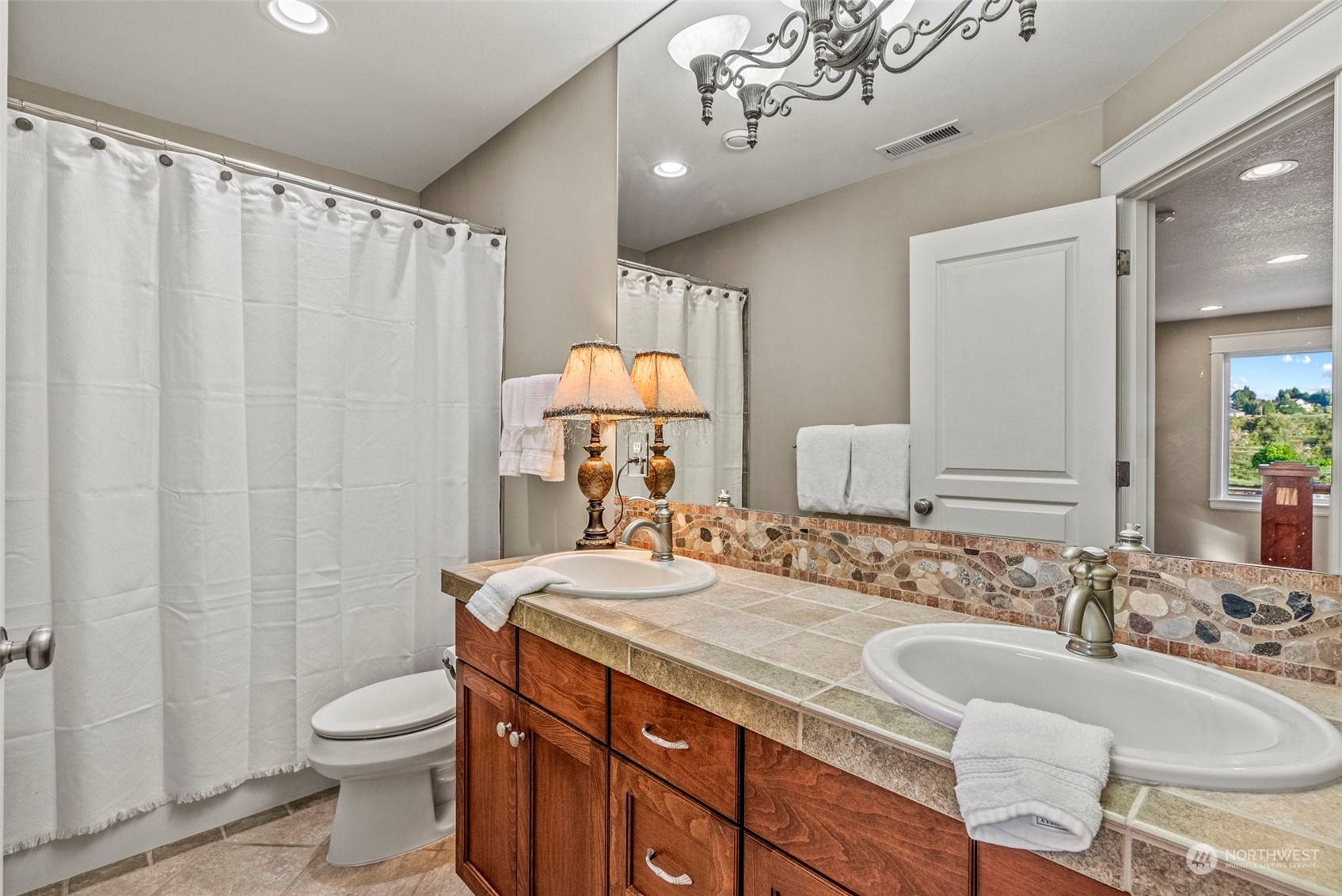 19501 Northwest Krieger Road Ridgefield, WA 98642 - Photo 29 of 38 a bathroom with a granite countertop sink and a mirror