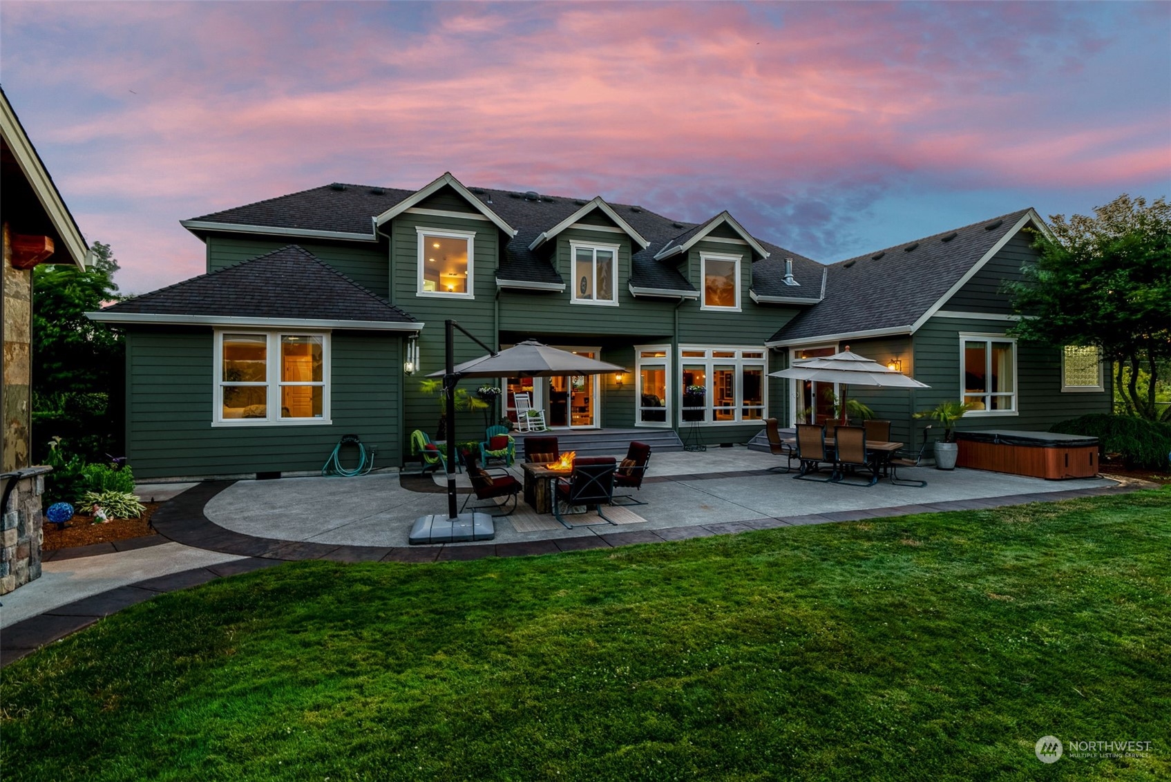 19501 Northwest Krieger Road Ridgefield, WA 98642 - Photo 35 of 38 a view of a big house with table and chairs under an umbrella