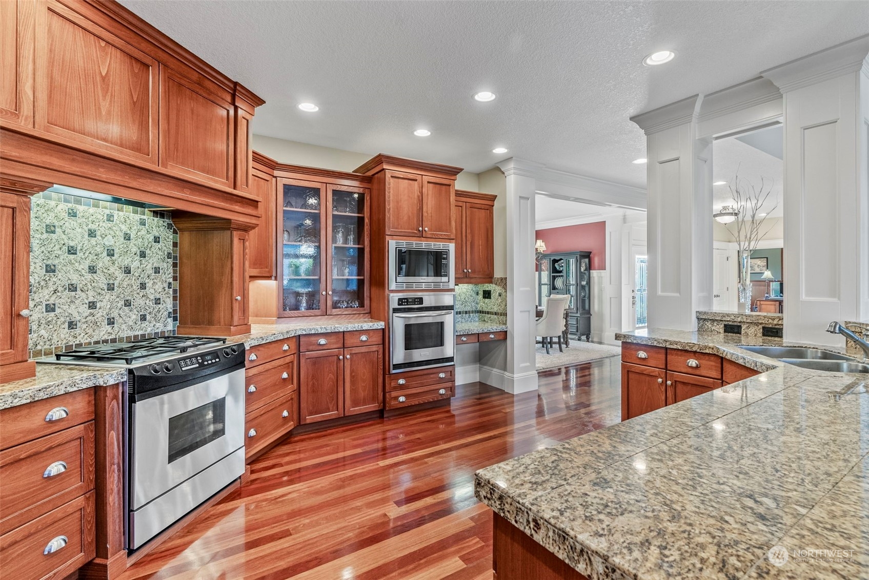 19501 Northwest Krieger Road Ridgefield, WA 98642 - Photo 9 of 38 a large kitchen with stainless steel appliances granite countertop a stove and large wooden cabinets