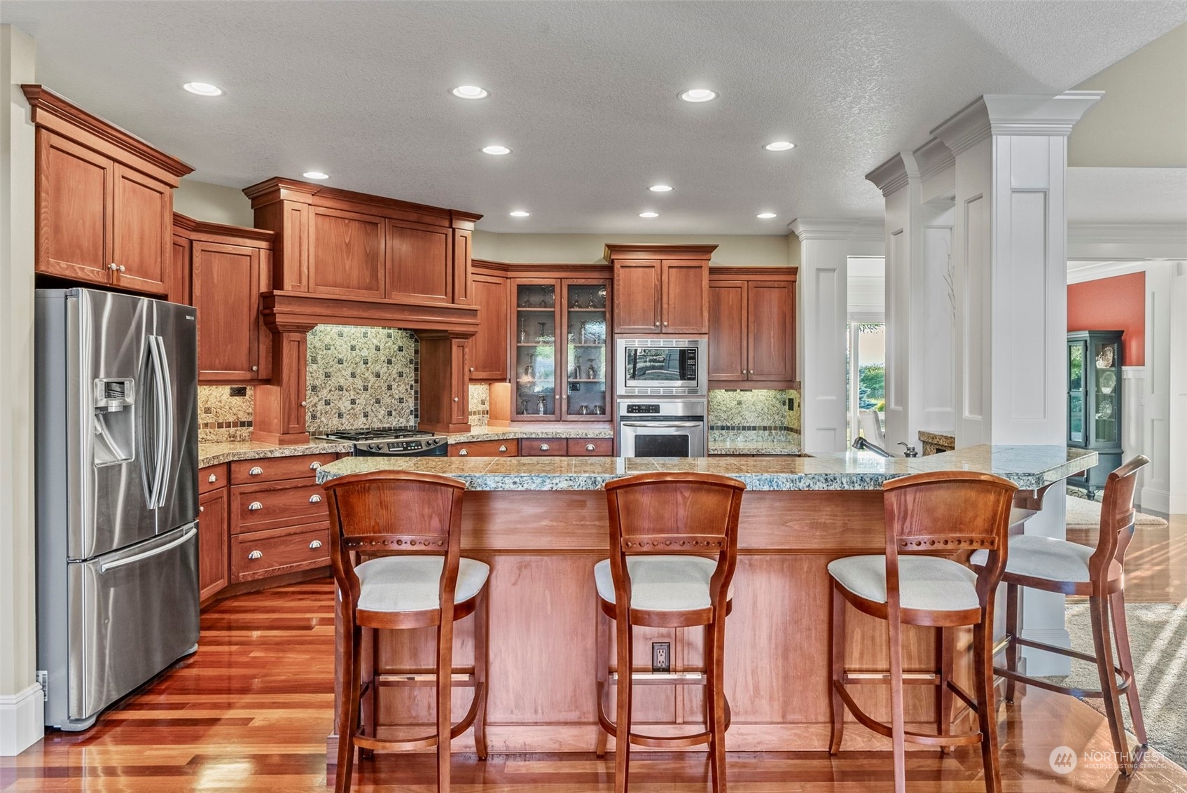 19501 Northwest Krieger Road Ridgefield, WA 98642 - Photo 10 of 38 a dining room with stainless steel appliances granite countertop a refrigerator and a stove top oven with wooden floor