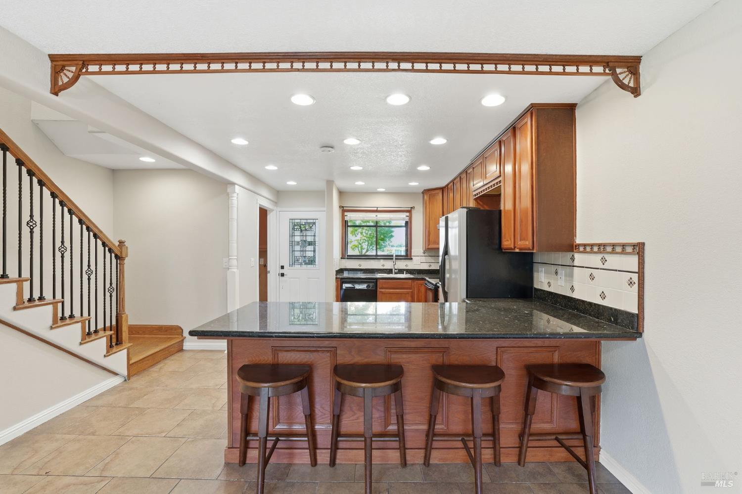 900 Southampton Road, Unit 169 Benicia, CA 94510 - Photo 11 of 21 a kitchen with granite countertop a table and chairs in it