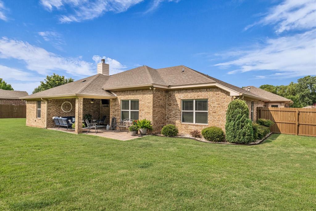 910 Springdale Lane Lorena, TX 76655 - Photo 37 of 39 Brick exterior featuring a covered patio with a paved surface