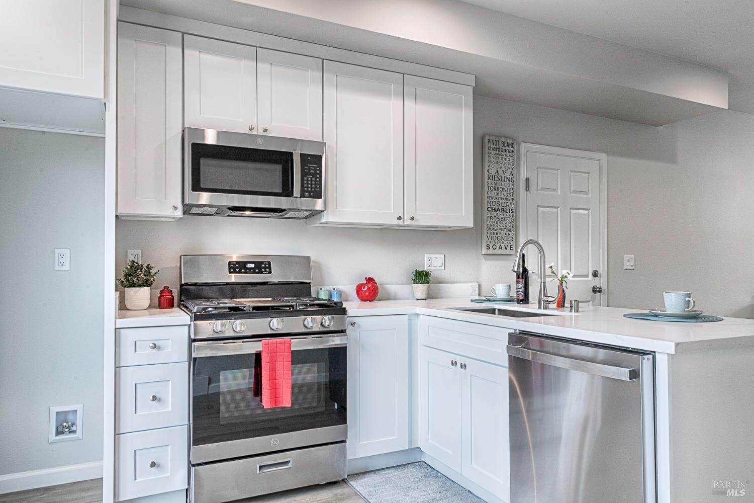 1964 Las Ventanas Drive Santa Rosa, CA 95407 - Photo 11 of 36 a kitchen with white cabinets and stainless steel appliances