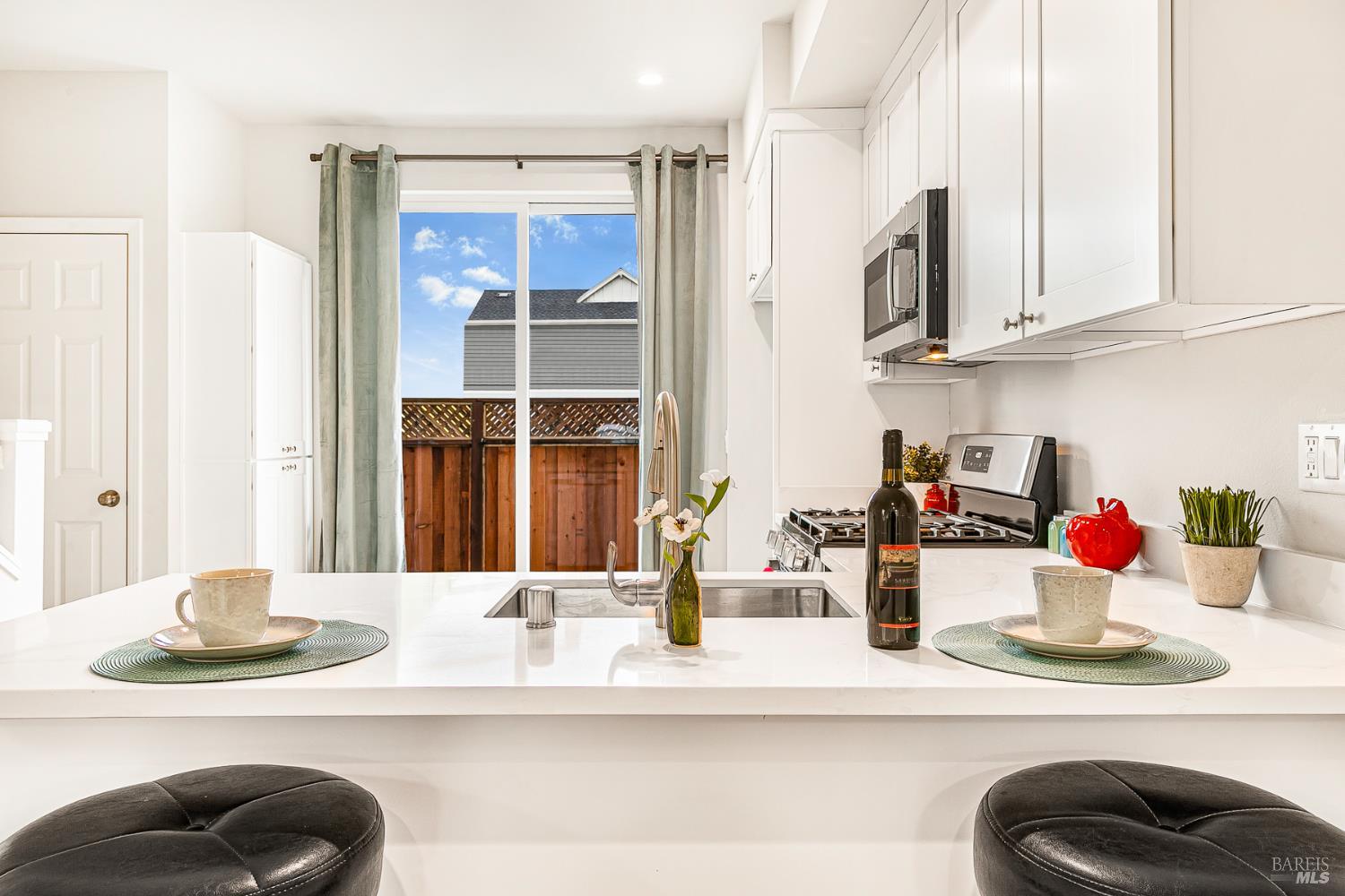 1964 Las Ventanas Drive Santa Rosa, CA 95407 - Photo 12 of 36 a kitchen with a sink dishwasher and a dining table with wooden floor