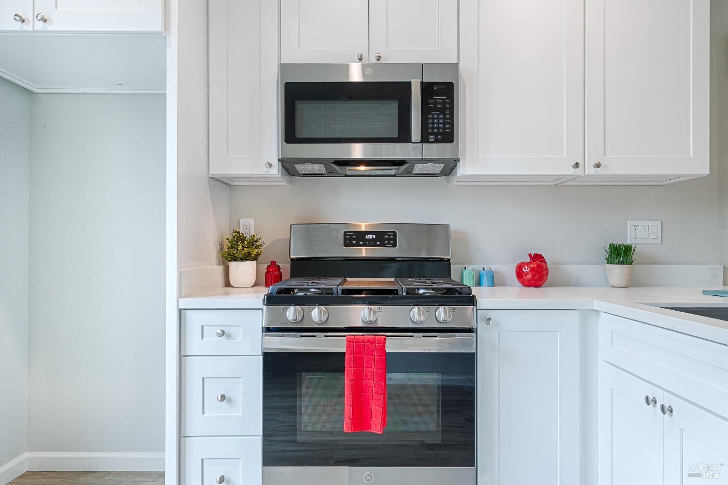 1964 Las Ventanas Drive Santa Rosa, CA 95407 - Photo 14 of 36 a kitchen with stainless steel appliances granite countertop a stove a microwave and wooden cabinets
