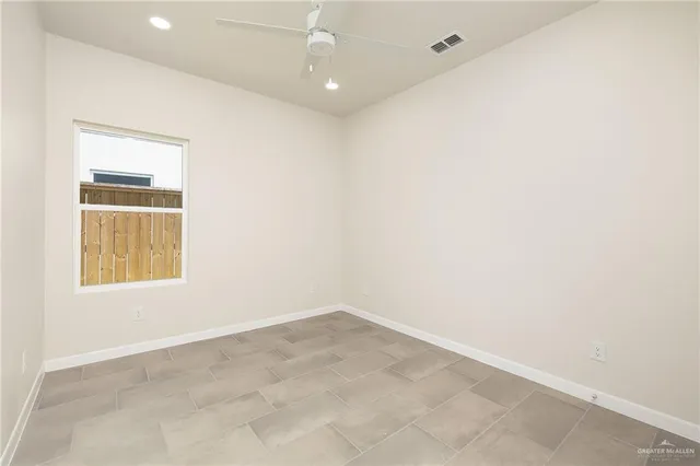 an empty room with windows and closet