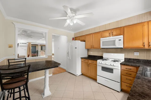 a kitchen with stainless steel appliances granite countertop a stove and a refrigerator