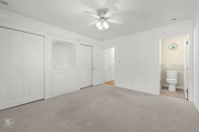 a view of an empty room and a bathroom