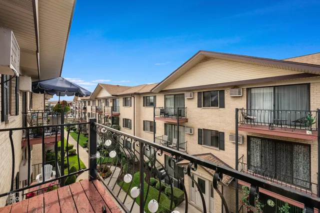 a view of a house with wooden deck