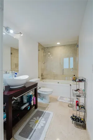 a bathroom with a tub sink and a mirror