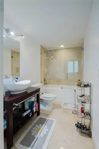 a bathroom with a tub sink and a mirror