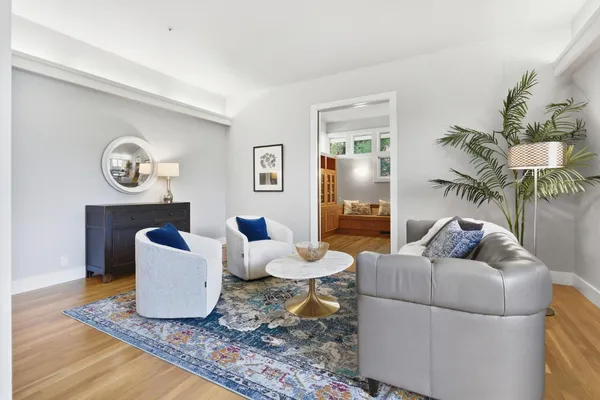 a living room with furniture and wooden floor