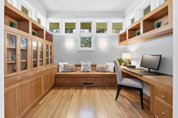 a view of a workspace with furniture and wooden floor