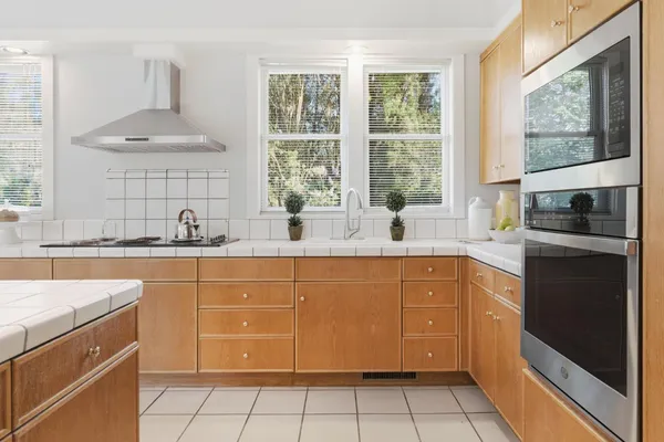 a kitchen with stainless steel appliances a sink stove and cabinets