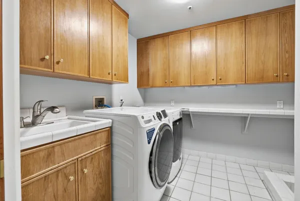 a utility room with a sink washer and dryer