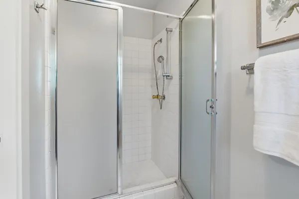 a bathroom with a glass shower door