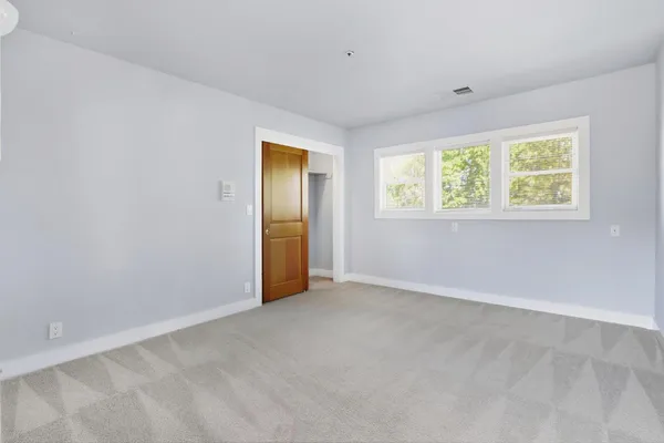 an empty room with windows and with yard