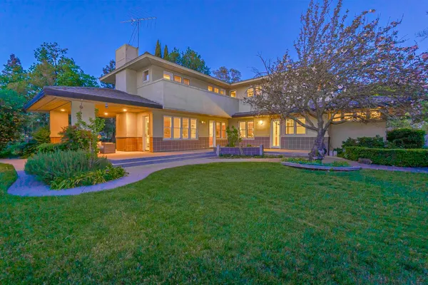 a front view of a house with garden
