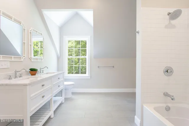 a bathroom with a tub sink and window