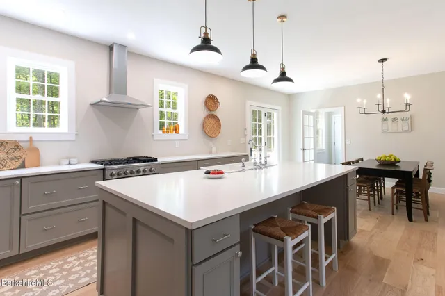 a kitchen with a sink stove and cabinets