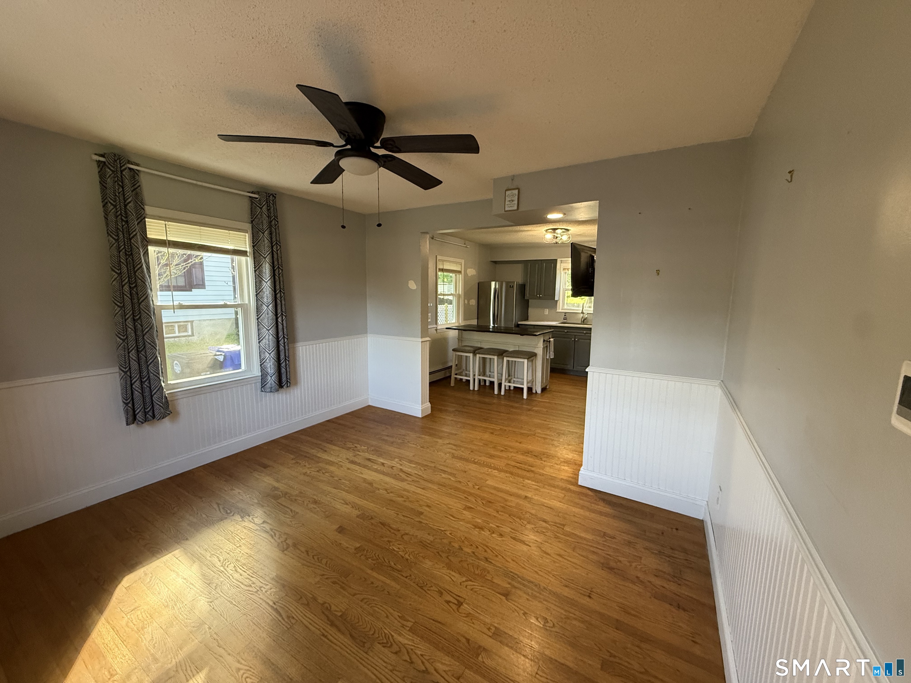 808 East Main Street Torrington, CT 06790 - Photo 19 of 40 a view of empty room with wooden floor and fan
