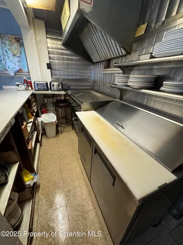 a view of large building with a yard and potted plants