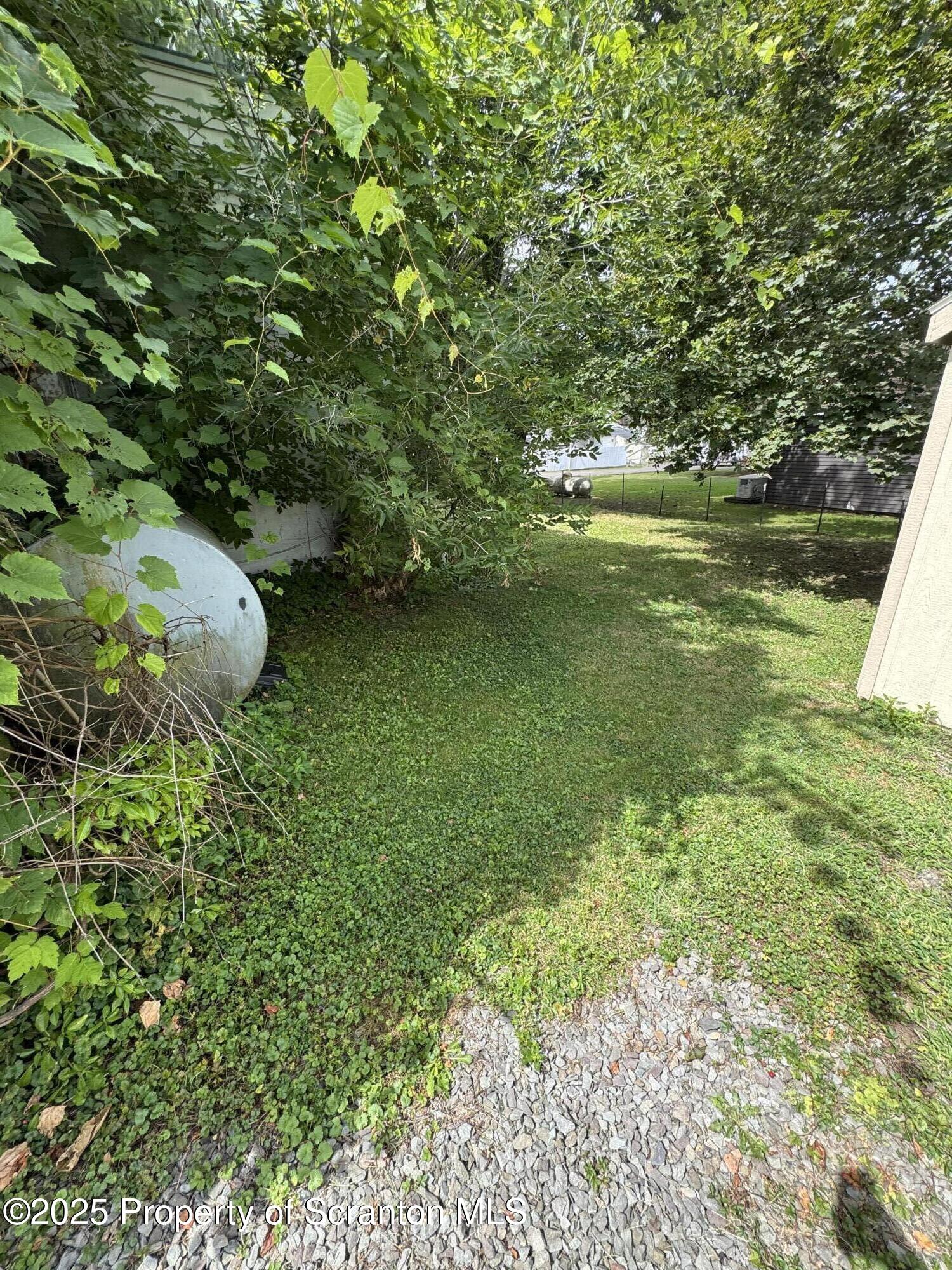 47 Broad Street New Milford, PA 18834 - Photo 21 of 65 a view of a garden with a lake