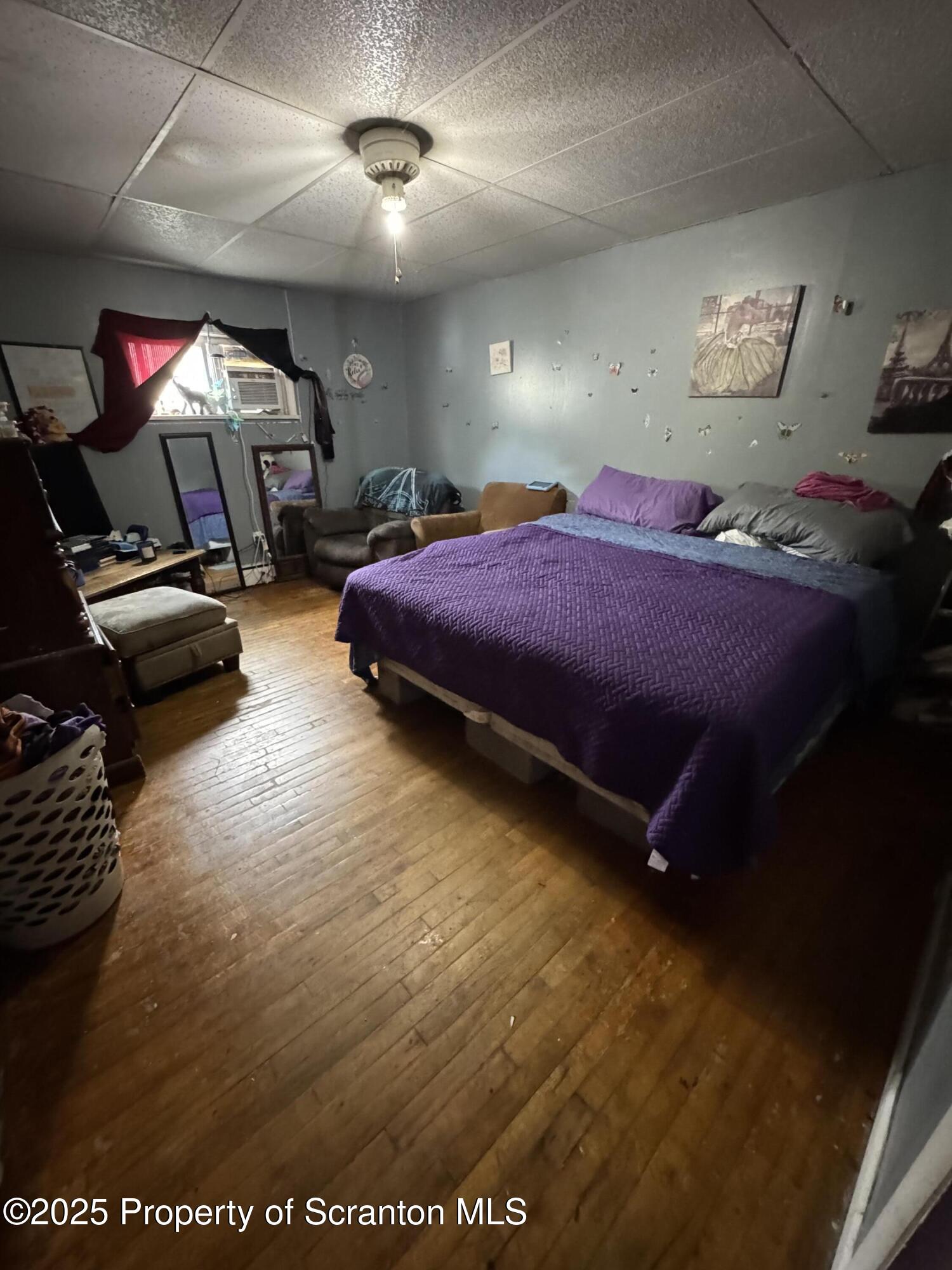 47 Broad Street New Milford, PA 18834 - Photo 26 of 65 a spacious bedroom with a bed and a chandelier