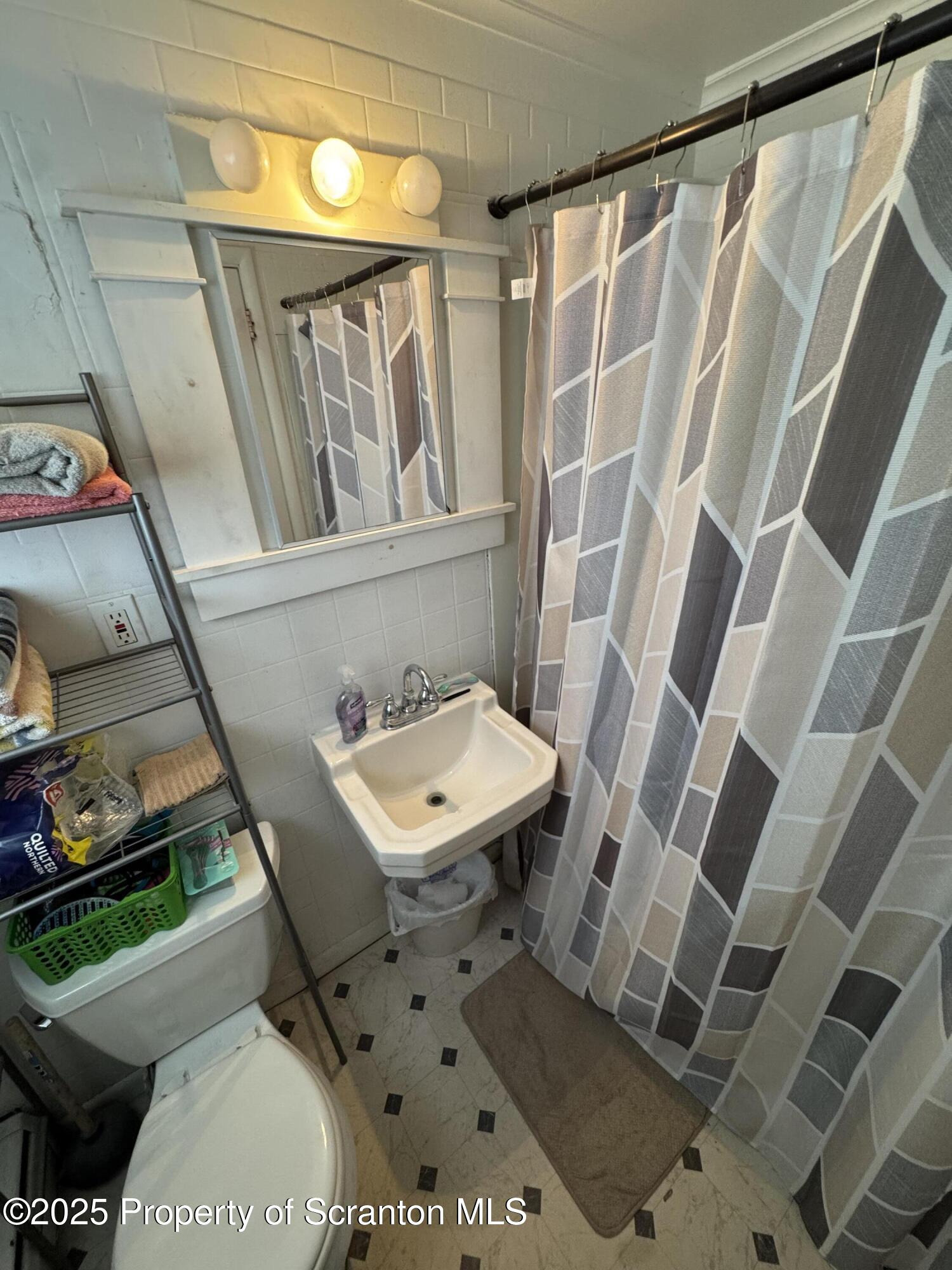 47 Broad Street New Milford, PA 18834 - Photo 50 of 65 a bathroom with a toilet and a sink