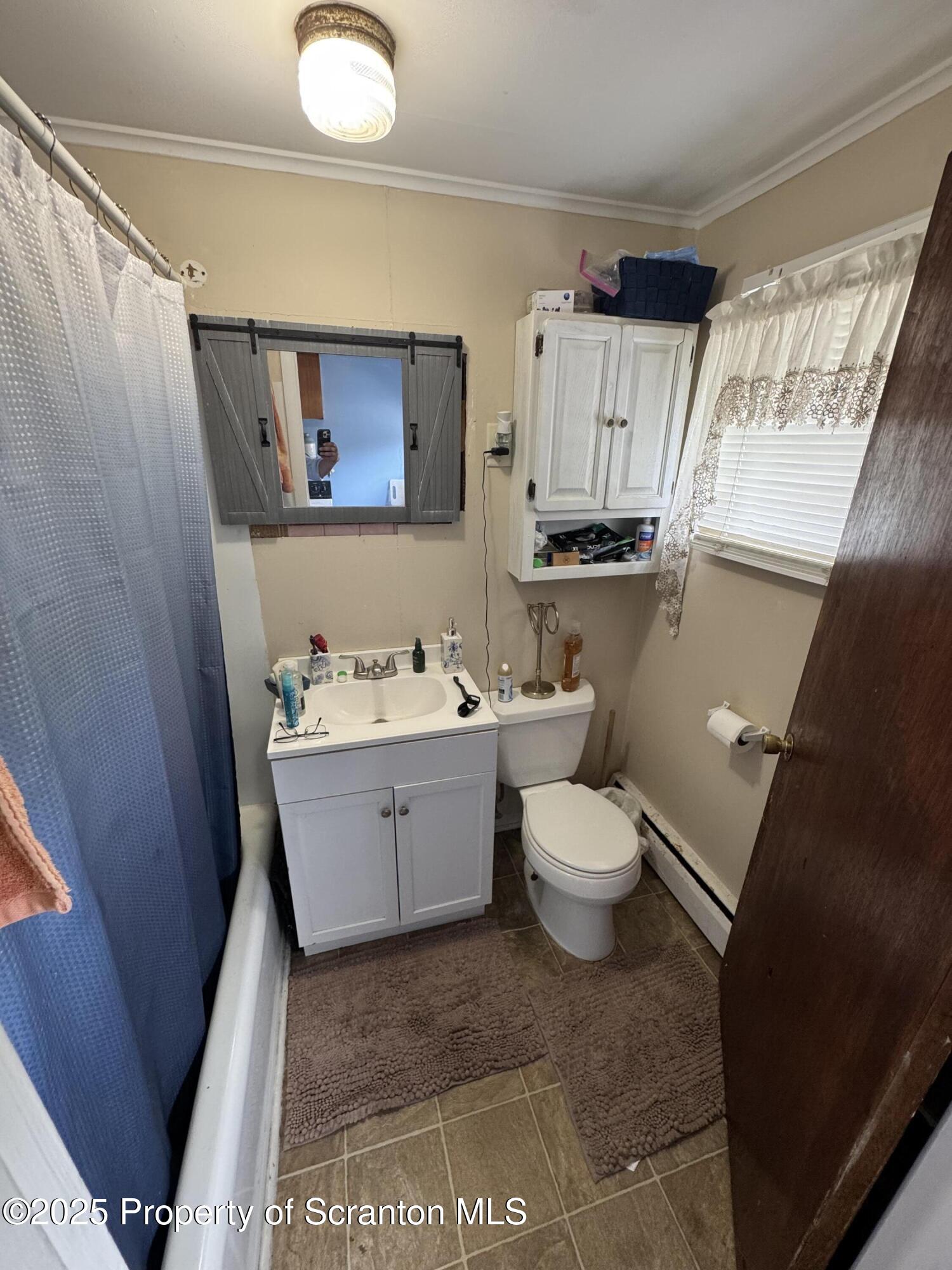 47 Broad Street New Milford, PA 18834 - Photo 64 of 65 a bathroom with a toilet sink and mirror