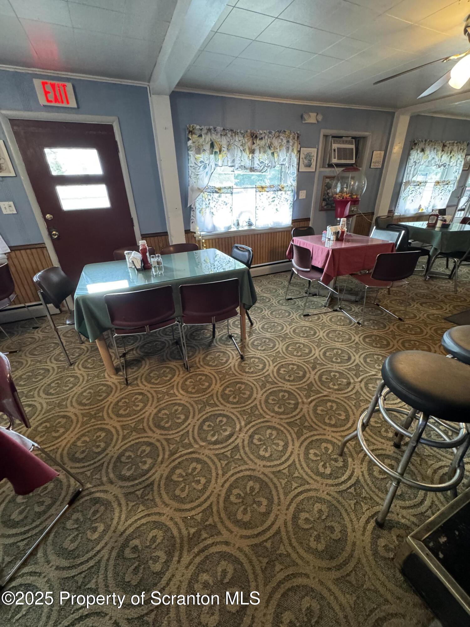 47 Broad Street New Milford, PA 18834 - Photo 10 of 65 a living room with furniture and a floor to ceiling window