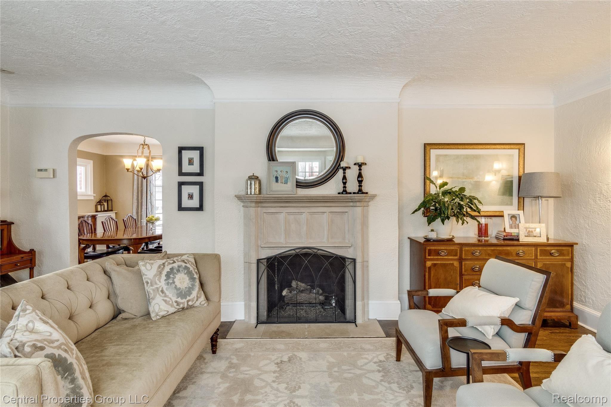 168 Hamilton Road Bloomfield Hills, MI 48301 - Photo 7 of 46 Living room features a limestone fireplace.