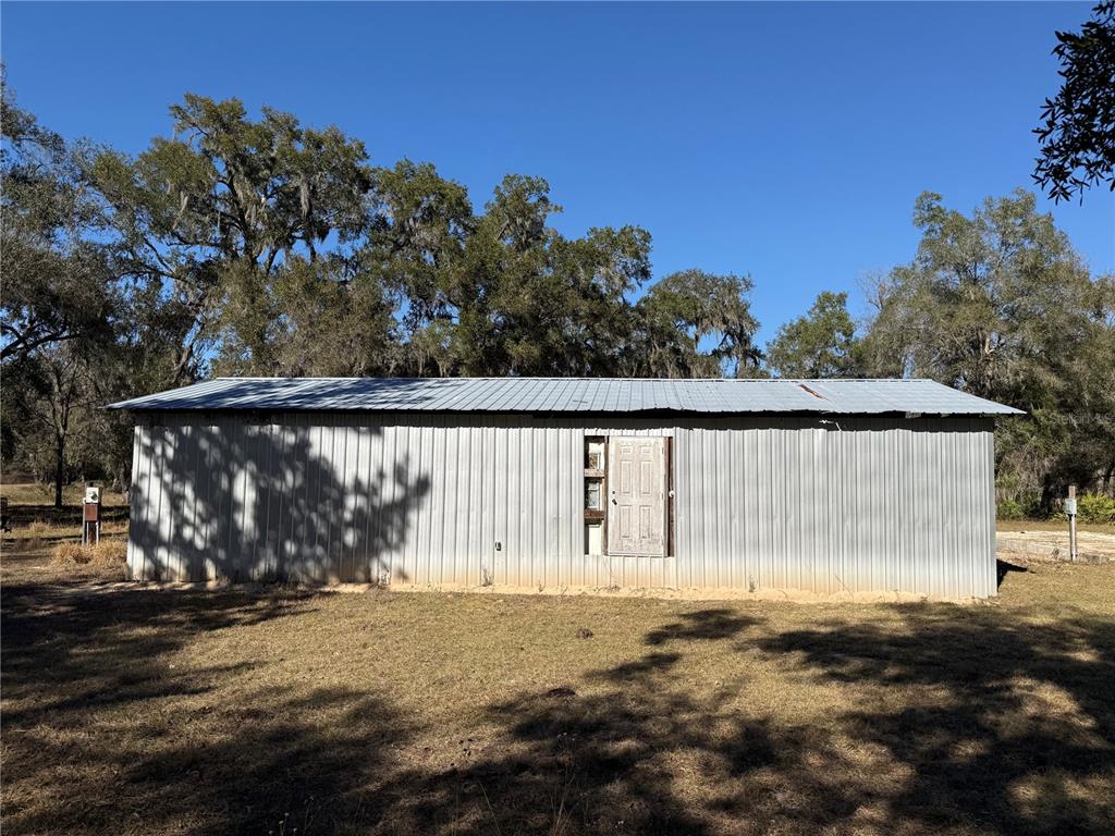18630 Bradshaw Road Dade City, FL 33523 - Photo 2 of 43 a backyard of a house with a bench and trees
