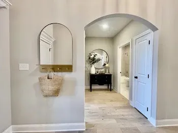 an empty room with window and ceiling fan