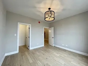 a view of hallway with bathroom and mirror